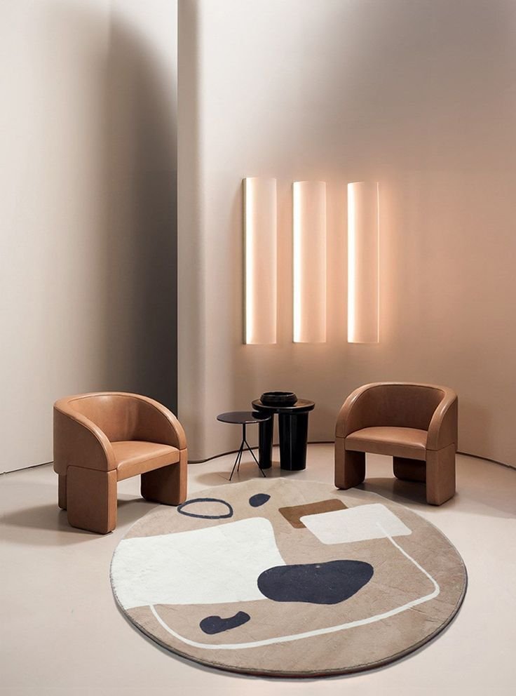 A bold, color-drenched living room with deep teal walls and a matching More Textiles area rug.